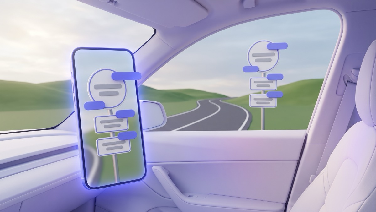 A phone standing on a car dashboard, its screen showing a roadside sign post with indigo translation chips over the sign panels, with a winding road and green hills through the windshield