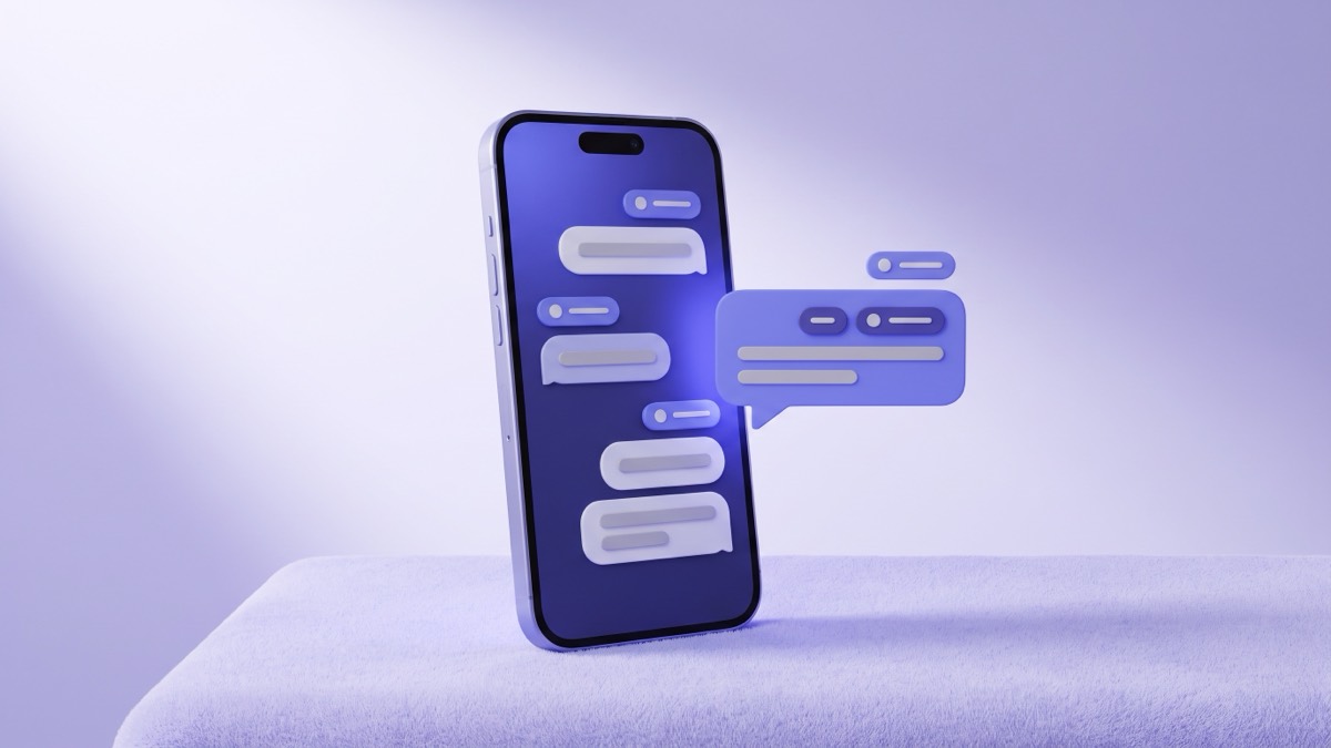 A phone leaning on a lavender surface with a chat thread of message bubbles on screen and an indigo chat bubble floating beside it