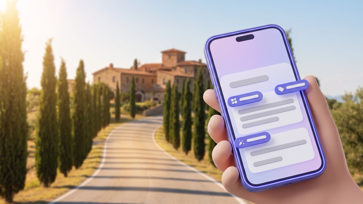 A phone in front of a sunny Italian village road, its screen showing a wooden sign post with indigo translation chips over the sign panels, with terracotta houses and a cypress-lined road behind