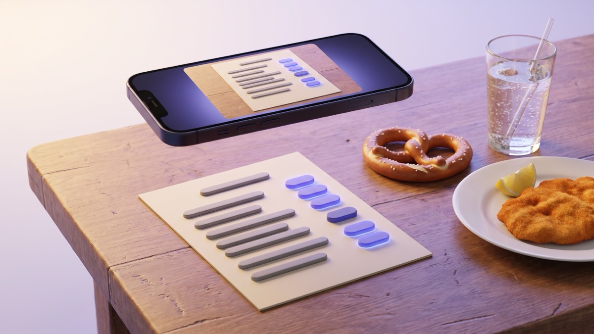 A phone floating above a wooden tavern table, its camera view showing a printed menu card with indigo translation chips over the text, beside a pretzel, a plate with a schnitzel and a glass of sparkling water